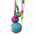 Load image into Gallery viewer, Colorful dog toy with balls and a handle held by a hand on a white background
